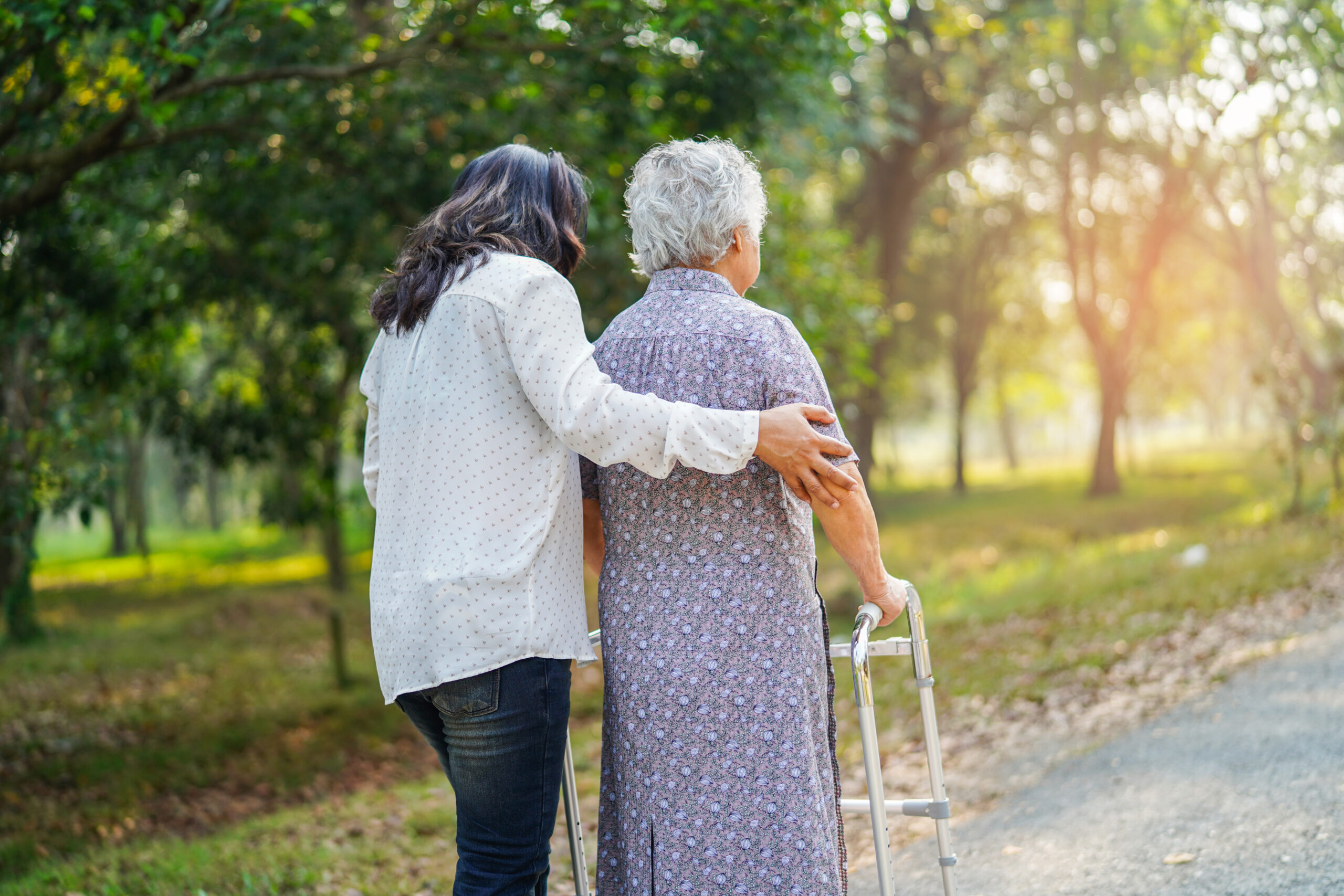 Help and care senior or elderly old lady woman use walker